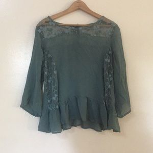 Sheer green blouse with simple floral detailing